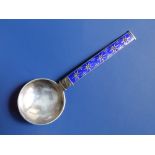 A Norwegian .925 metal spoon with circular bowl and blue enamelled handle decorated stars/