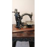 A Victorian Willcox and Gibbs hand sewing machine.