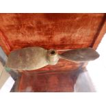 A small twin blade brass propellor, 17", a wooden pulley and three rowlocks. (5)