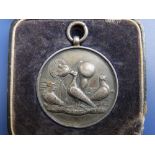 A Birmingham silver pigeon racing medal in damaged Porter & Sons case - '1st Prize Andover