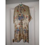 An early 20thC Chinese cream silk fully embroidered robe overall length 42".