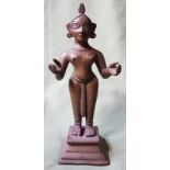 An antique Indian brass female figure - traces of red wax, 9" high.