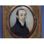 Charles Jagger - An early 19thC oval watercolour miniature portrait of a gentleman in a black jacket