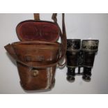 A pair of WWI military binoculars, dated 1915 to the leather case - 'MEDIUM'.