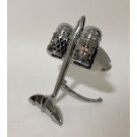 A chrome salt & pepper set in the form of an aeroplane with enamelled London crests.