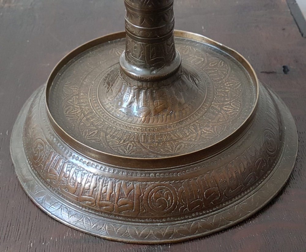 An antique Islamic copper alloy candlestick, decorated overall with stylised foliate decoration - Image 2 of 3