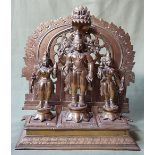 A large Indian brass altar group comprising three figures, the central figure with inset ruby