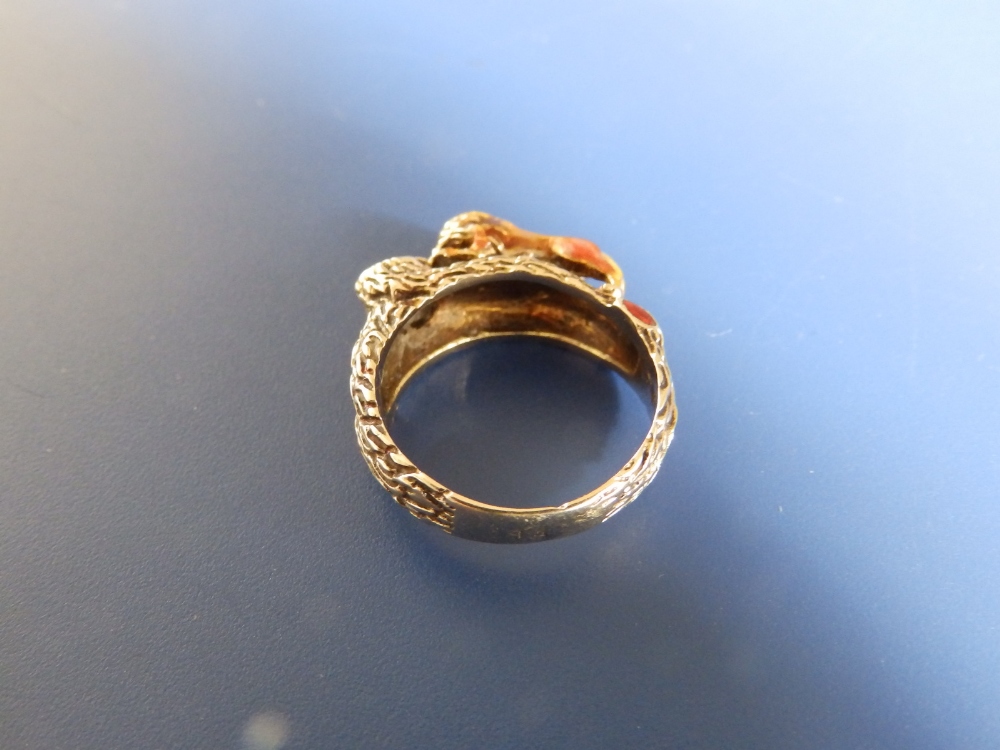 A '14' yellow metal ring modelled with a lion gazing into a red enamelled pool. Finger size N. - Image 4 of 4