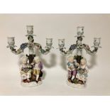 A pair of late 19thC Meissen style porcelain twin branch figural candelabra, underglaze blue scissor