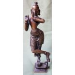 An antique Indian brass figure, the eyes and forehead inlaid with silver, 9" high.