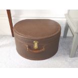 A brown 'Guaranteed Genuine Cow Hide' hat box.
