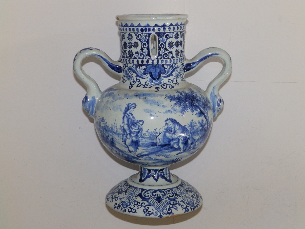 A 19thC delft blue & white two-handled vase, having pierced cylindrical neck, painted with