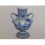 A 19thC delft blue & white two-handled vase, having pierced cylindrical neck, painted with