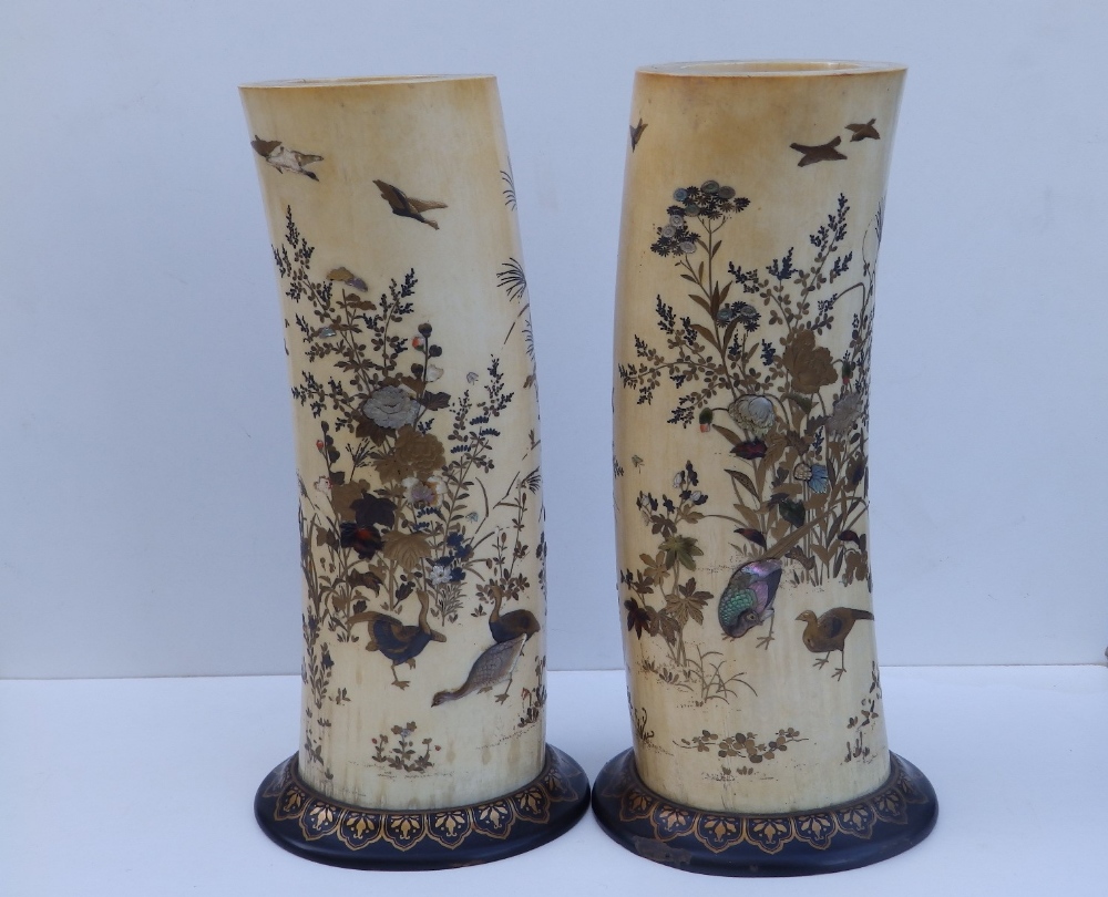A pair of Japanese Meiji period shibayama inlaid ivory tusk vases, the sides decorated to show