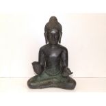 A 19thC Indian bronze Buddha, modelled sitting in the Reassurance posture, 12.5" high.
