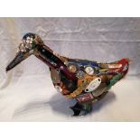 An American painted wooden duck with applique decoration comprising numerous household objects and