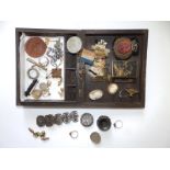 A carved wooden box containing sweetheart brooches and a small collection of costume jewellery.