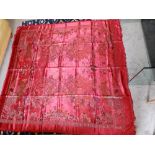 A 20thC Chinese red satin machine woven cover/throw, decorated with children at play amidst