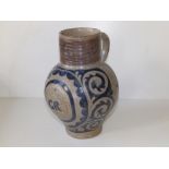 An 18thC German Westerwald stoneware jug commemorating 'GR' decorated in blue & manganese, 8.5"