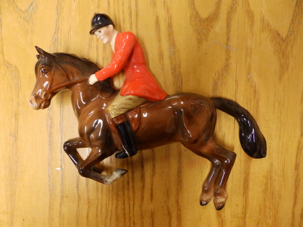 A Beswick hunstman on horse wall plaque - one ear chipped.