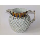 A dated George III pearlware jug decorated in Pratt colours to the leaf patterned neck, brown