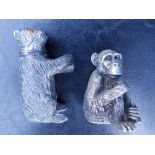 A silver model of a seated chimpanzee, 2.5" and a silver plated bear pepperette, 3". (2)