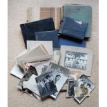 A large collection of photographs in albums and loose, appearing to document a military family