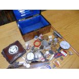A box containing a collection of modern badges and other collectors' items.