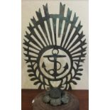 A large brass naval crest of sunray design, 12.5" excluding stand.