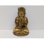 A small gilt metal seated Buddha, wearing ornate headdress, 6" high.