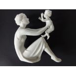 A Kaiser Porcelain white biscuit figure of a mother and child, 8.5" high.