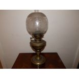 A Victorian brass oil lamp with shade, 19" high overall.