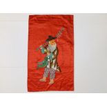 A Chinese red silk rectangular panel embroidered with the figure of a fisherman, 24" x 13" overall.