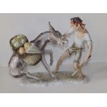 An Alka Kunst Bavarian porcelain group depicting a youth attempting to lead a reluctant mule, 10"