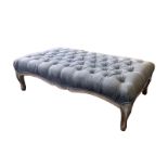 A large 20thC reproduction button upholstered stool, on cabriole feet, 47" x 27".