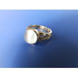 A '9k' moonstone ring - 'M&M'. Finger size O.