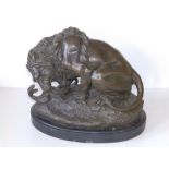 After Bayre - a 20thC bronze study of a lion fighting with a snake, on black marble base, 11"