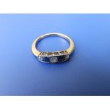 A five stone sapphire & diamond ring on '18ct' yellow metal shank. Finger size O/P.