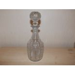 A 19thC panelled cut glass decanter with stepped shoulders, 11" high overall.