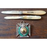 Two silver fruit knives with mother-of-pearl handles and an enamelled silver Maltese Cross medal. (