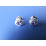 A pair of amethyst & diamond cluster earrings in '18k' white metal.