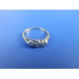 A small three stone diamond ring. Finger size L.