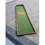 A Victorian folding mahogany table top bagatelle board, 96" overall.