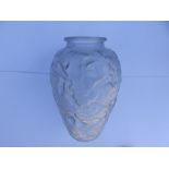 A press moulded art glass vase decorated overall with raised flowers, 10" high.