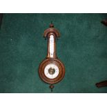 A Victorian walnut wall barometer, 23" high overall.