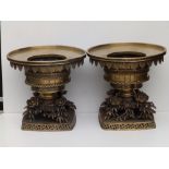 A pair of Chinese bronze censers, the circular upper stages with a fringe of lappets and fret