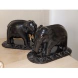 A small pair of ebony elephants, 8" across - missing tusks.