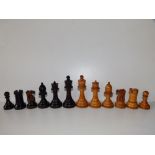 An early 20thC Staunton pattern wooden chess set with weighted bases, the kings 4" high.