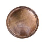 A large Eastern 19thC copper tray, having overall stylised engraved decoration with a central