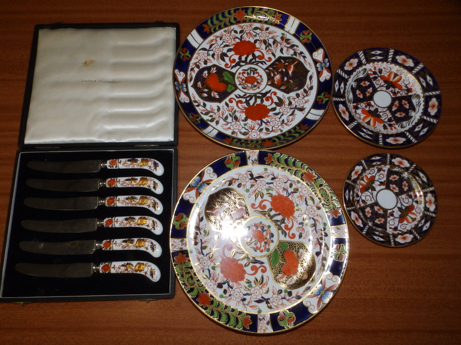A cased set of six Royal Crown Derby pistol grip tea knives and four various Royal Crown Derby